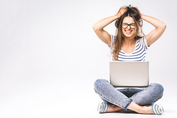 Business concept. Portrait of depressed woman in casual sitting on floor in lotus pose and holding laptop isolated over white background. Using phone.