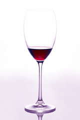glass with red wine on a light background