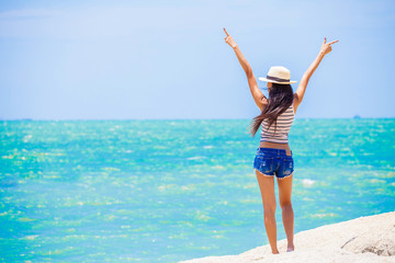 back view Happy  Freedom woman enjoy standing on the sea beach hand up