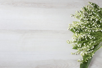 on a light table a bouquet of lilies of the valley