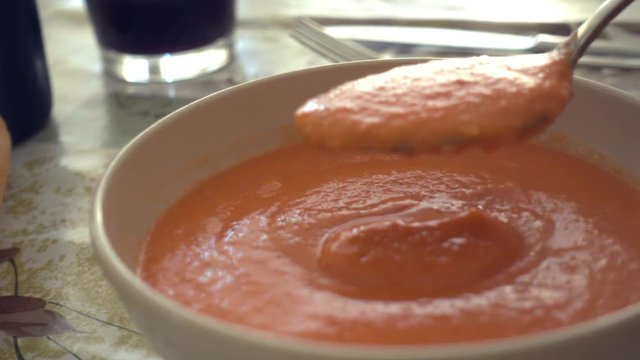 Eating fresh and tasty bowl of Gazpacho.Typical summer cold soup of raw blended vegetables,classic of spanish cuisine.Include tomato, cucumber, bell pepper, onion and garlic, olive oil, wine vinegar.