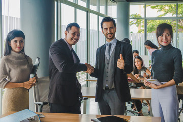 Executives and secretaries Joining hands after successful business deal.