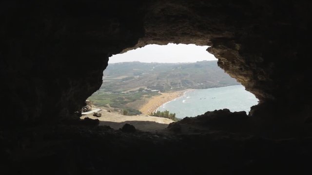 Clip of a cave located in Malta. throught the opening we can see a beautiful landscape with sea.