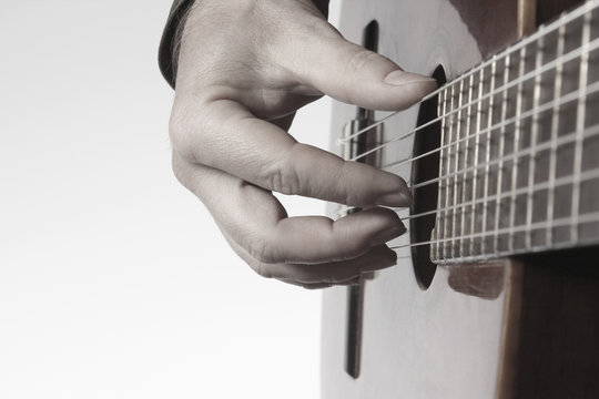 in the chord playing classical guitar closeup