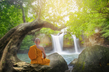 monk practice meditation at haew suwat waterfall in thailand,Khao Yai national park ,Thailand