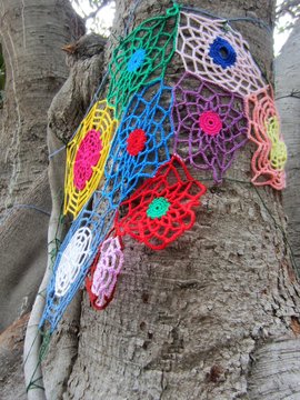Crochet shapes on tree trunk