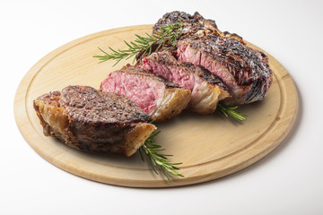 Fiorentina T-bone steak cut on round wooden chopping board