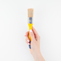 Woman hand holding new paint brush isolated