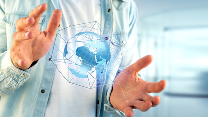 Businessman holding a Connected network over a earth globe concept on a futuristic interface - 3d rendering