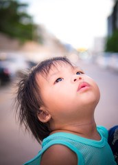child girl looking up into the sky and feeling wonder
