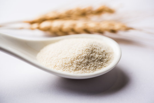 Raw Unprepared Semolina Flour Also Known As Rava Powder In Hindi In Bowl Or Spoon. Close-up Isolated On White Or Moody Background. Selective Focus