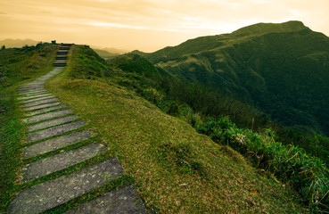 Stepping stone footpath leading over a hill into a storybook landscape on the Taoyuan Valley Trail in Taiwan