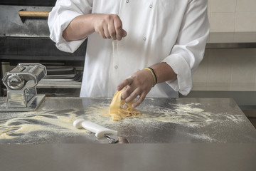 Sprinkling Semolina flour over fresh pasta Chef separates the pasta sheets with the help of powdered Semolina
