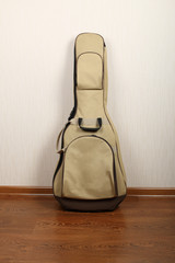 Modern soft case from beige fabric for a classic acoustic guitar