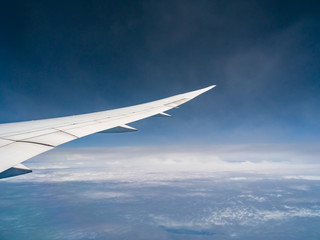 Fototapeta na wymiar View from airplane window with blue sky and white clouds, background for travel holiday trip, Aircraft on the sky.