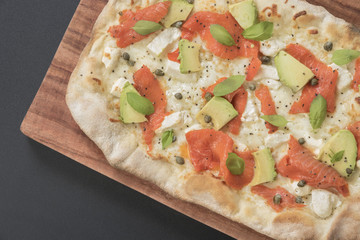 Close-up of a delicious smoked Salmon Pizza. Delicious smoked Salmon Pizza