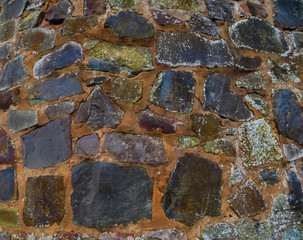 beautifully folded old wall of stones, on the street