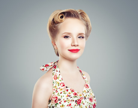 Beautiful young prom woman with retro style make up and hairdo. Cute pin-up girl smiling