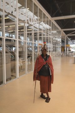 Portrait of maasai man in traditional clothing standing with