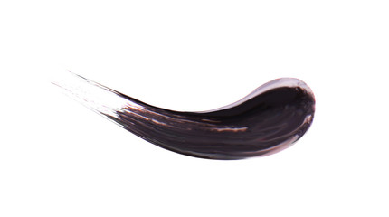 Black stroke of mascara on a white background. Texture of black mascara for eyelashes isolatedon white. Smear of black mascara for eyelashes. Black mascara or paint smears