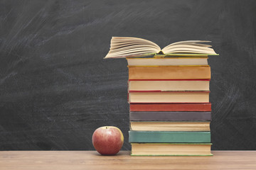 Open book, hardback books on wooden table. Back to school. Copy space for text. Education background.