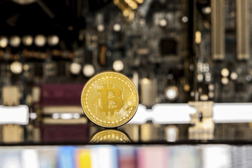 Golden bitcoin in front of a  motherboard dynamically zoomed into the bitcoin concept for crypto...