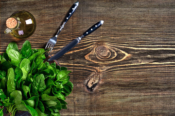 Spinach baby leaves on wooden background. Top view. Copy space