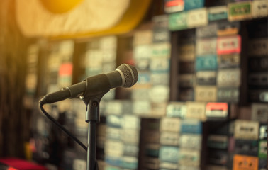 Microphone on abstract blurred of tape cassette wall or speaking,vintage filter 