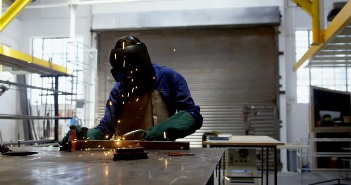 Female welder using blow torch on a rod 4k