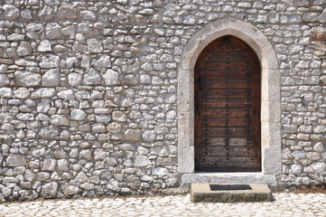 Ancient wooden door and stone wall
