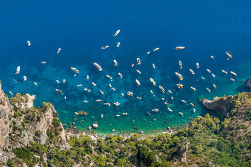 Fototapeta na wymiar Yachts over blue crystalline water in Capri, Italy