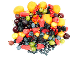 lots of fresh different berries on a white background