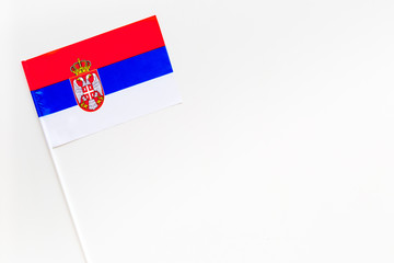 Serbian flag concept. small flag on white background top view copy space