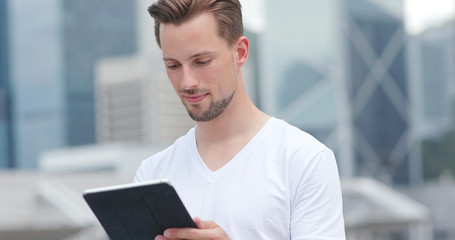 Caucasian young man use of tablet computer