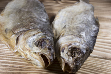 Dried fish on the table. Salty dry river fish on a dark wooden background.top view