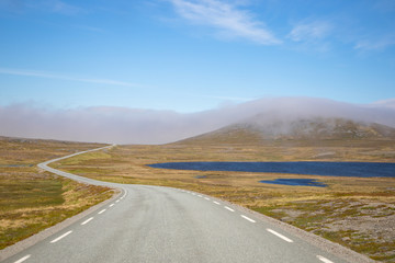 Steppe road and beautiful sky in sunny day in Norway