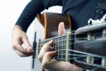hands of the musician playing on classical guitar