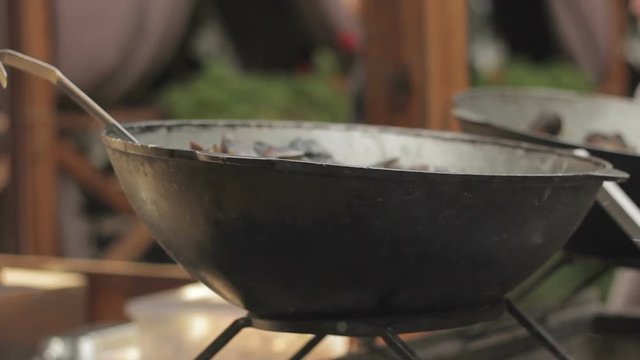 cooking food for homeless. large cauldron with food on the street. Charity