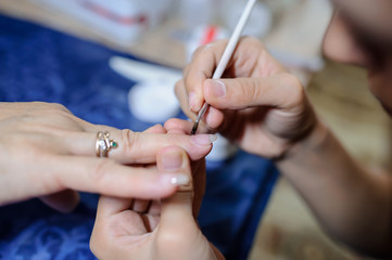 Obraz na płótnie Canvas Manicurist master at nail work