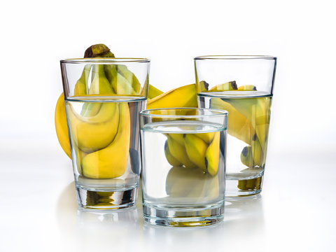 Fresh Bananas and glass of water on the white background