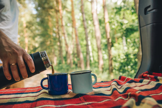 Man Hand Pour On Coffee Into Metal Cups From Thermos Bottle. Copy Space