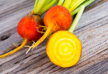golden beets raw on rustic wood background