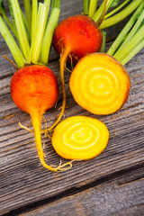 golden beets raw on rustic wood background