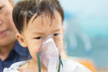 A moody boy who is sick with a chest infection after a cold or flu has difficulty breathing and...