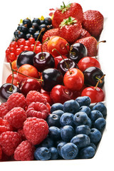 A mixed arrangement. Assorted berries including strawberry, cherry, blueberries, raspberries, black currant and red currant, isolated on white background. Close-up.