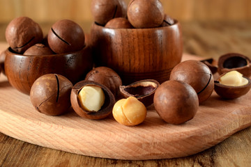 Macadamia nuts against the wooden background