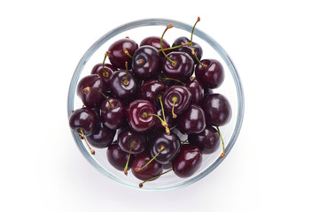 Sweet cherry in glass pot, isolated on white background. Close-up. Top view.