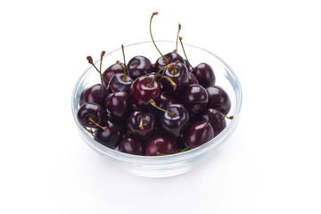Sweet cherry in glass pot, isolated on white background. Close-up.