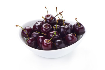 Sweet cherry in white pot, isolated on white background. Close-up.