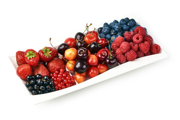 A mixed arrangement. Assorted berries including strawberry, cherry, blueberries, raspberries, black currant and red currant, isolated on white background.